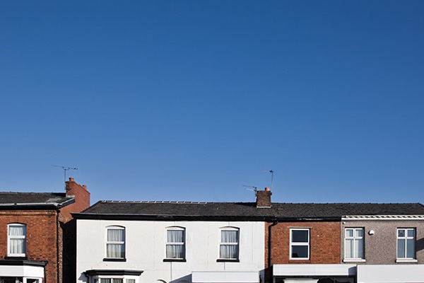 Row of houses with expanse of blue sky