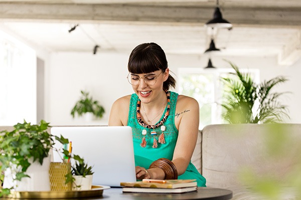 Fashionable woman working on laptop